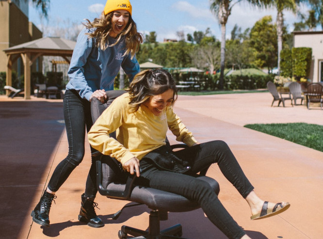 Two women having fun in light activity outdoors